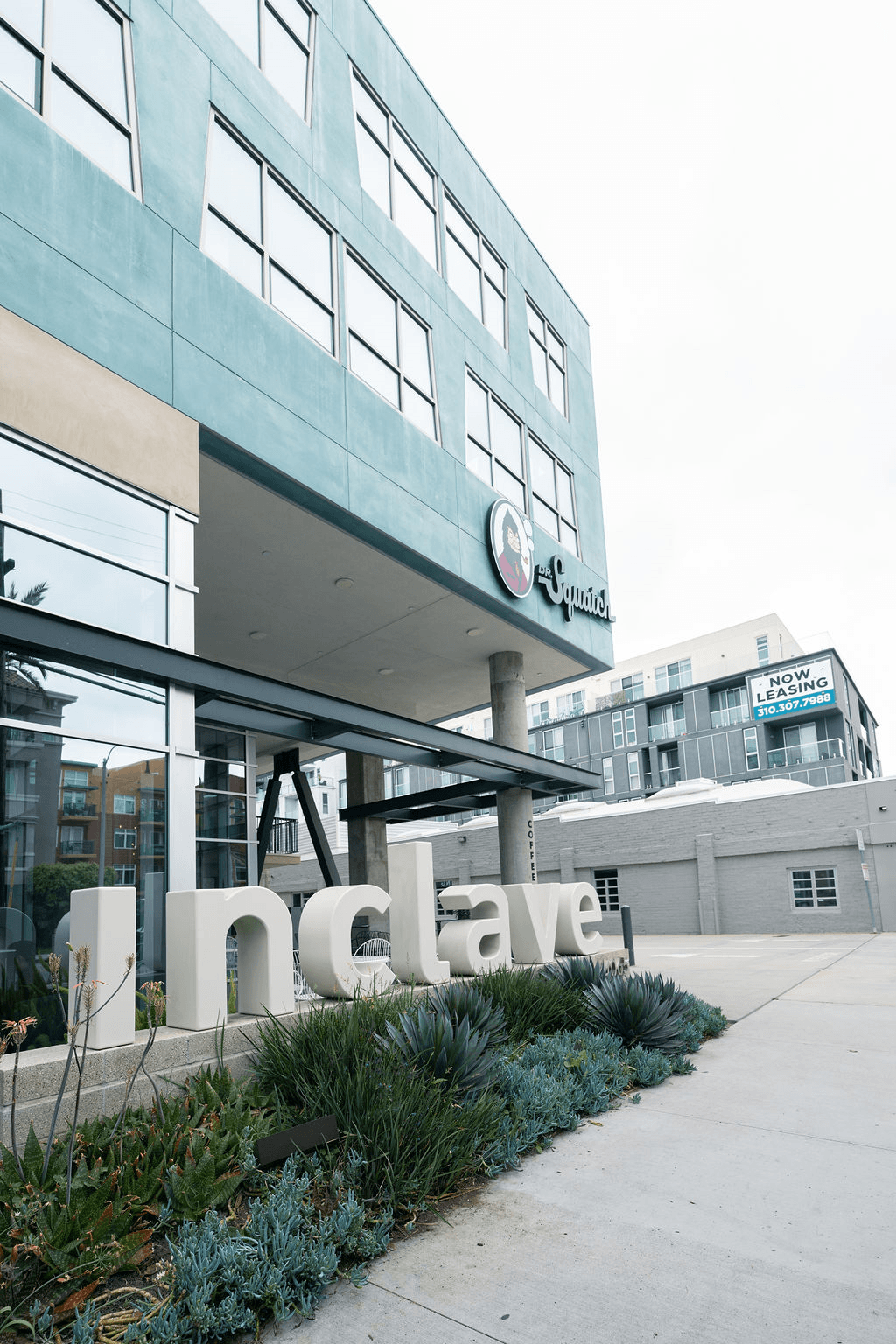 the facade of an office building with a sign that reads qualcomm